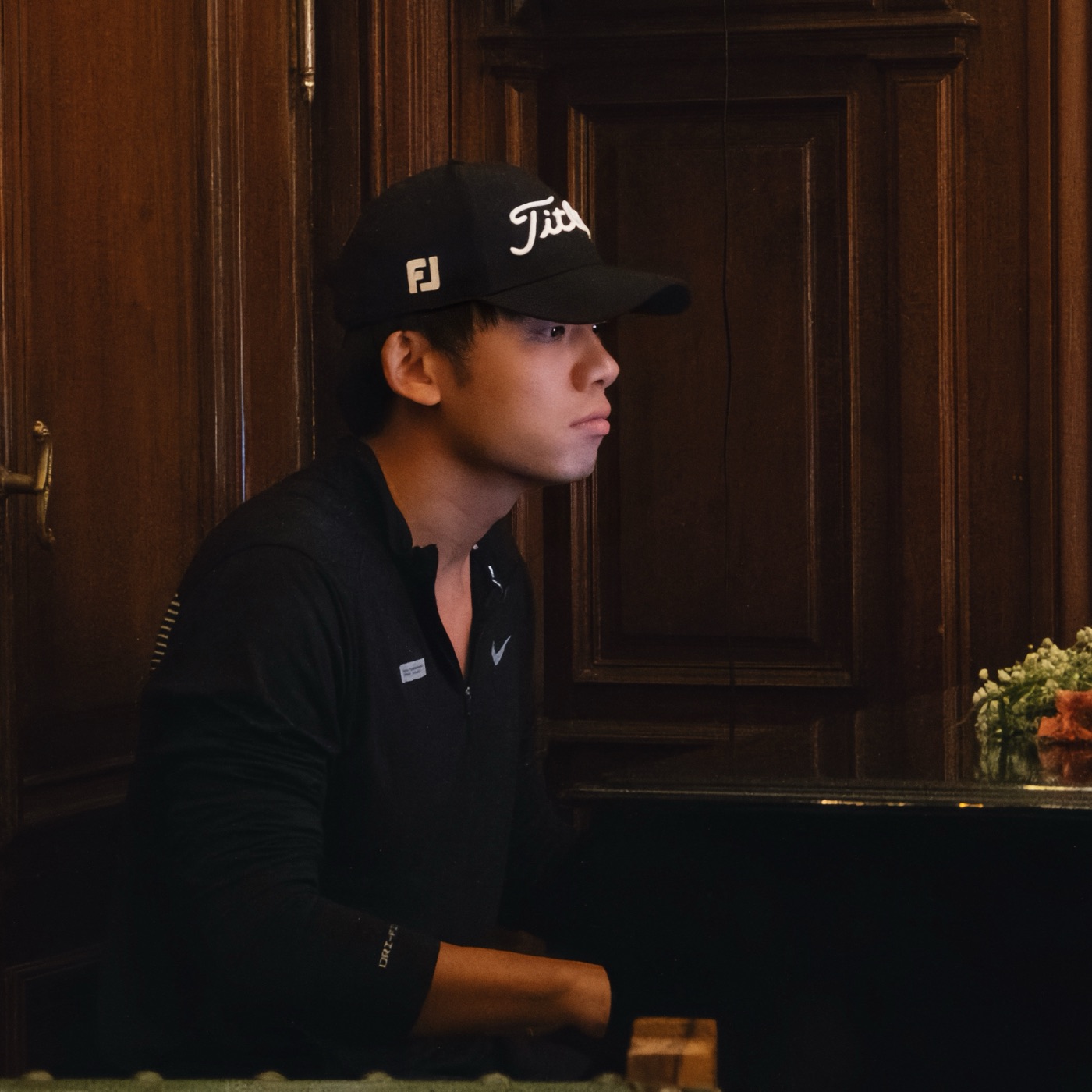 Dexter in a black cap, looking off to the side