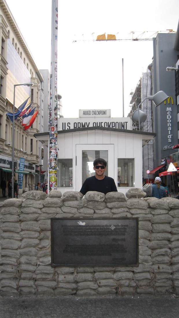 Dexter standing at Checkpoint Charlie in Berlin