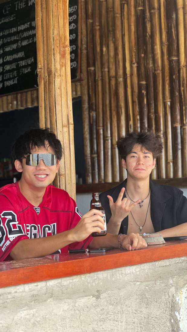 Dexter and a friend at a bamboo bar in the Philippines
