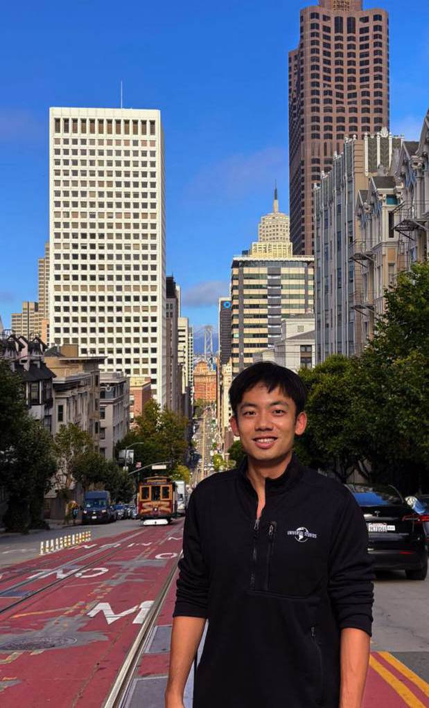 Dexter on a San Francisco street with the skyline behind